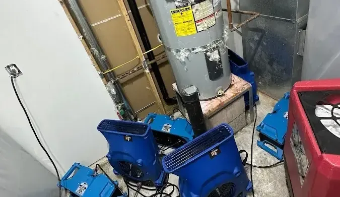 Drying equipment arranged beside a water heater in a closet