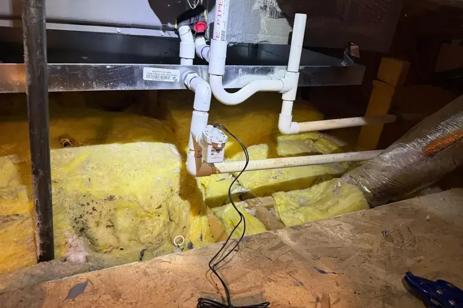Air handler drain pipes above wet attic insulation
